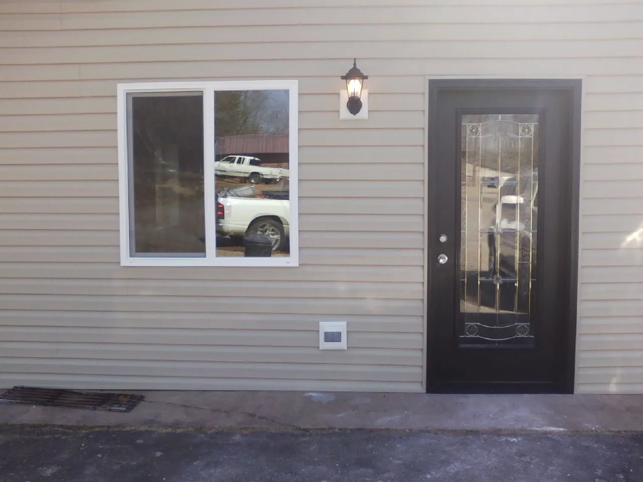 New siding, window and entry door on the side of an addition in Bunker Hill
